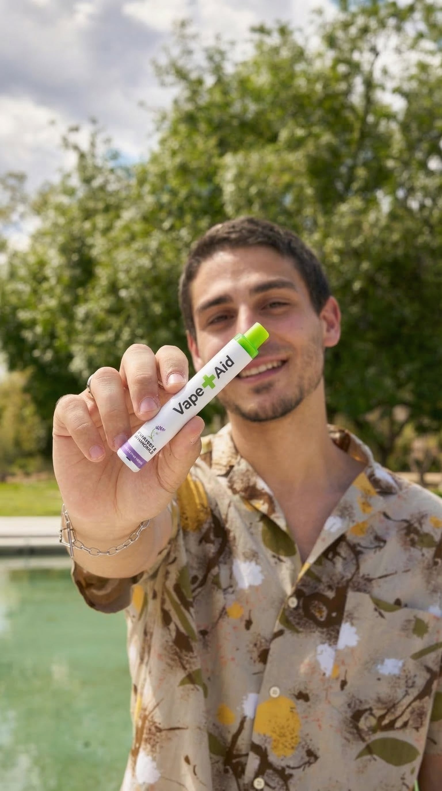 Man holding up a Vape+Aid diffuser with outdoors