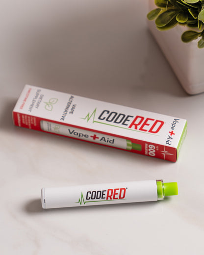 Code Red Vape+Aid nicotine-free vape alternative pen with packaging, styled on a light marble surface