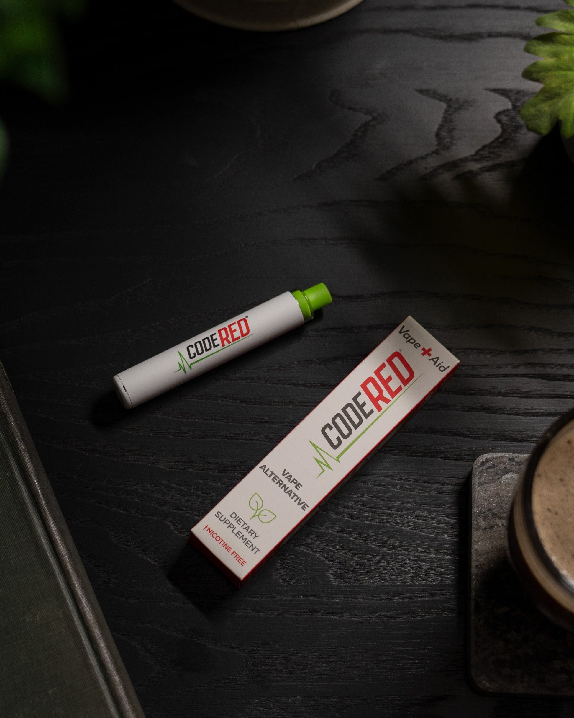 Code Red Vape+Aid and packaging on a dark wooden surface