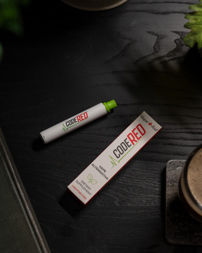 Code Red Vape+Aid and packaging on a dark wooden surface